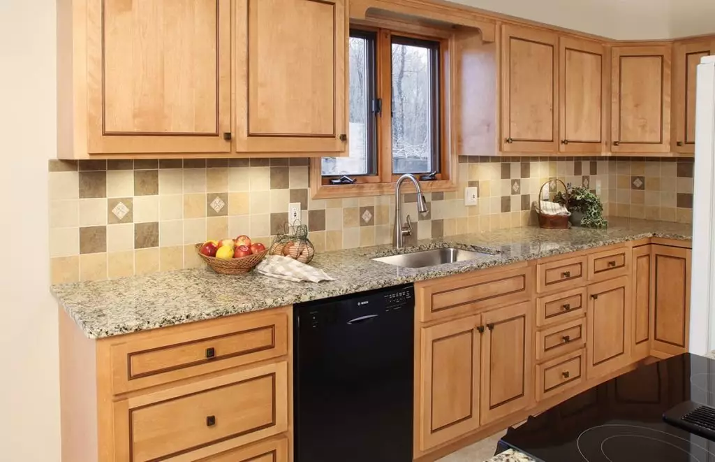 Kitchen sink and countertop, featuring a gray sink and white marble countertop.