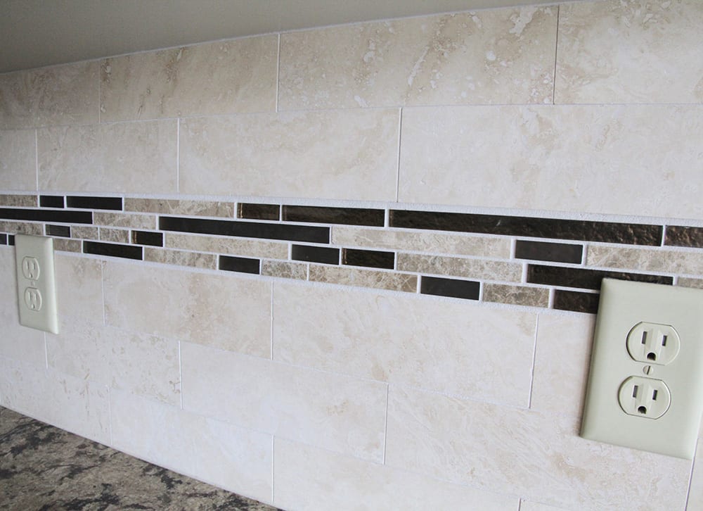 Kitchen backsplash layout guide with white tile installation