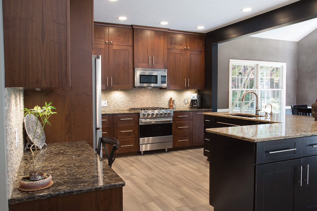 a picture of a brown kitchen after a refacing cabinet project in Ohio, featuring the proper position of appliances and a centre island with a sink