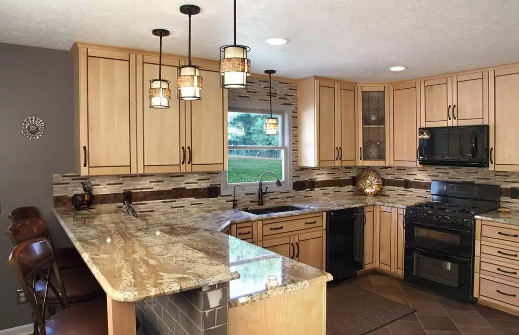Remodeled kitchen, featuring new wood cabinets, stainless steel appliances, and a gray backsplash.