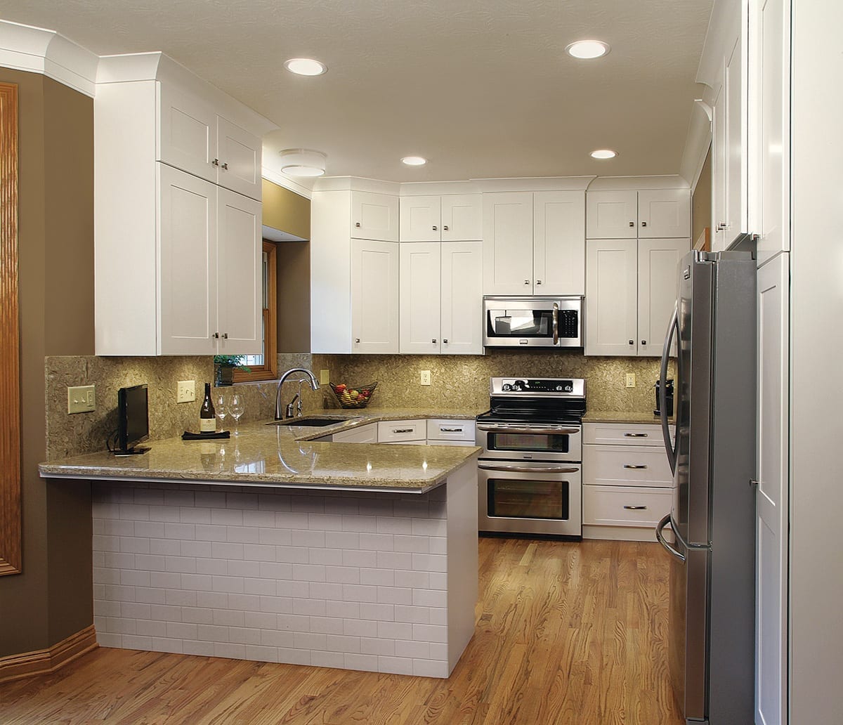 picture of a kitchen After refacing in a brown hue and installed gorgeous cabinets that extend to the ceiling, and perfect placement of the appliances 2