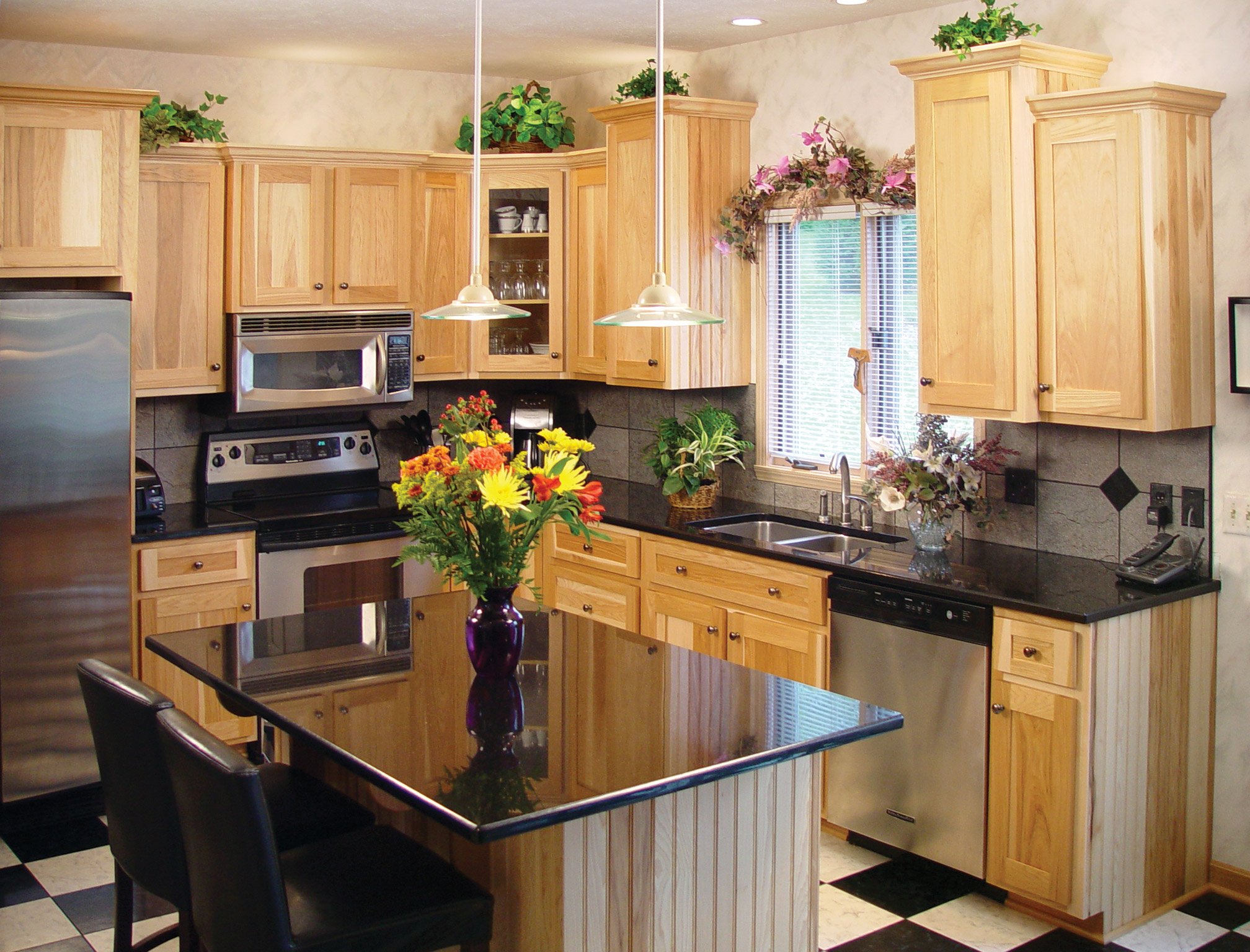 Flowers in a vase on an island in a refaced kitchen