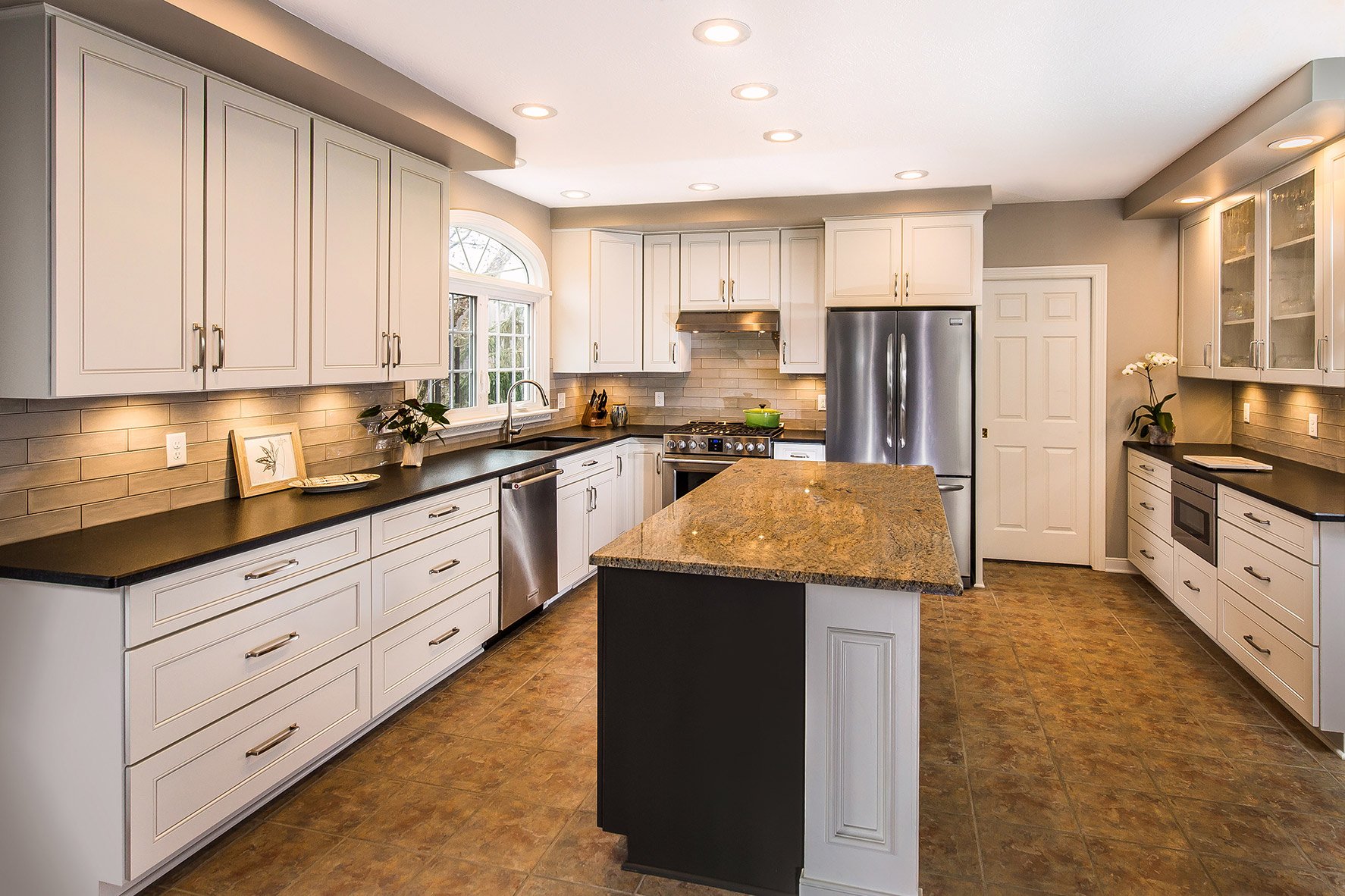 A refaced kitchen with new white cabinet doors