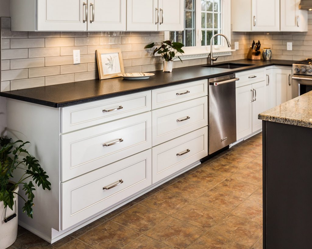 White cabinet drawers in a newly-refaced kitchen
