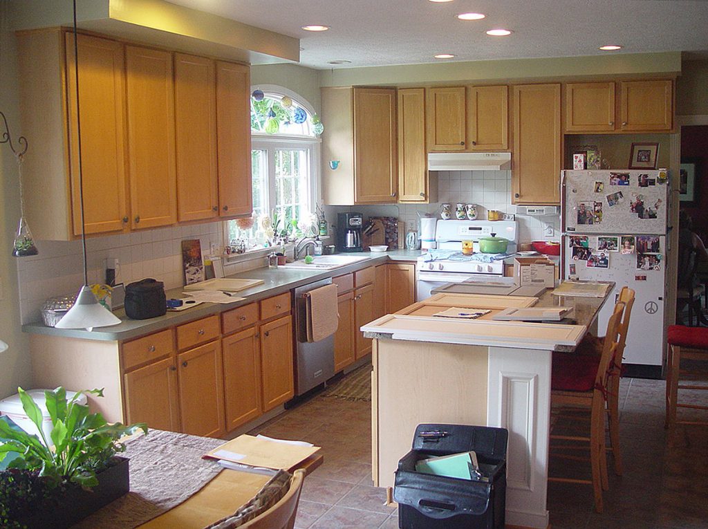 Kitchen remodels, showing new cabinet doors, granite countertops, and a tile backsplash.