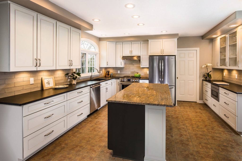 a side view picture of a beautiful kitchen refacing project with a kitchen cabinet extended to the ceiling with a center island and brown tiled countertops 1