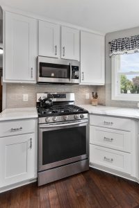 Birch Solid Wood Kitchen Cabinets in an all white kitchen