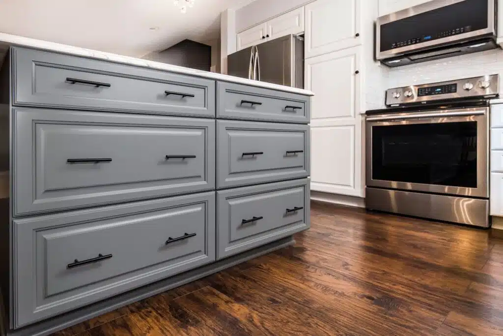 Refaced gray kitchen island with lower cabinets converted to drawer banks