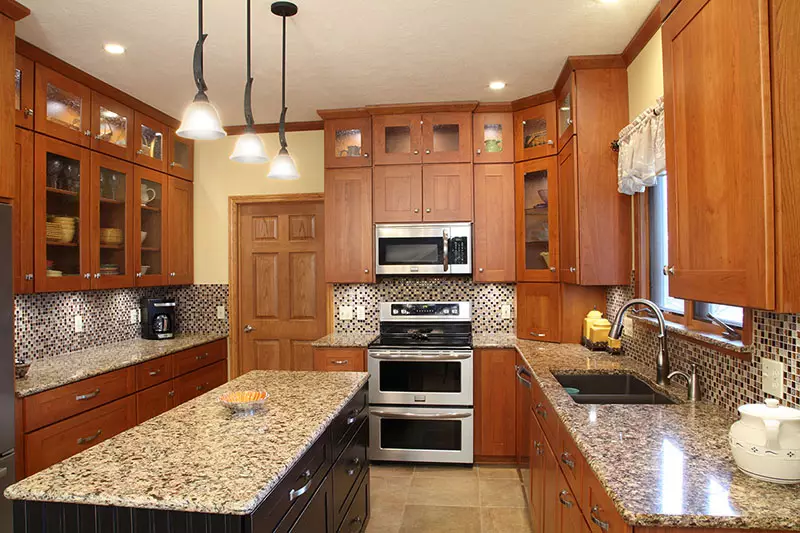 newly refaced kitchen with cherry wood cabinets