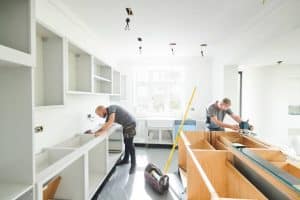 Carpenters installing the cabinets in the kitchen area