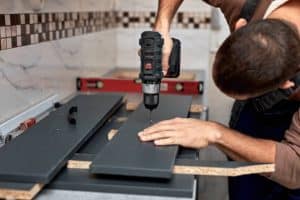 a handy man doing some kitchen cabinet refacing 