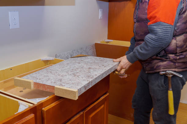 Professional worker placing a new laminate block for a kitchen countertop installation