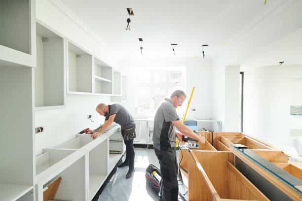 workers doing professional kitchen countertop installation