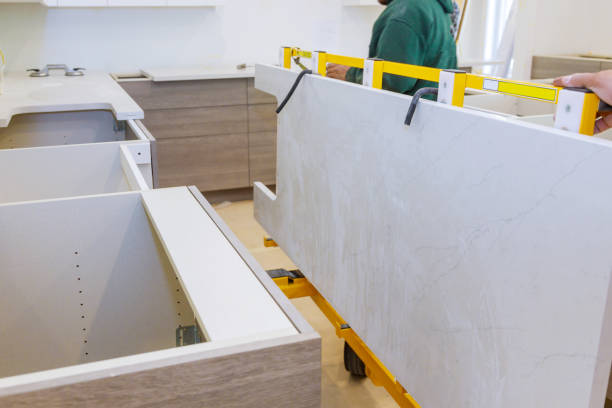 Workers lifting maple granite for a kitchen countertop installation