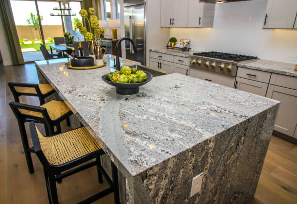 Modern kitchen counter top with bar stools and decorator items