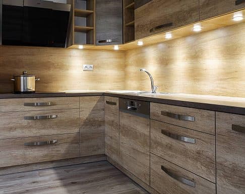 Brown kitchen cabinets with under lightning