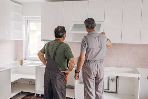 Worker Installation of a new kitchen refaced cabinets.