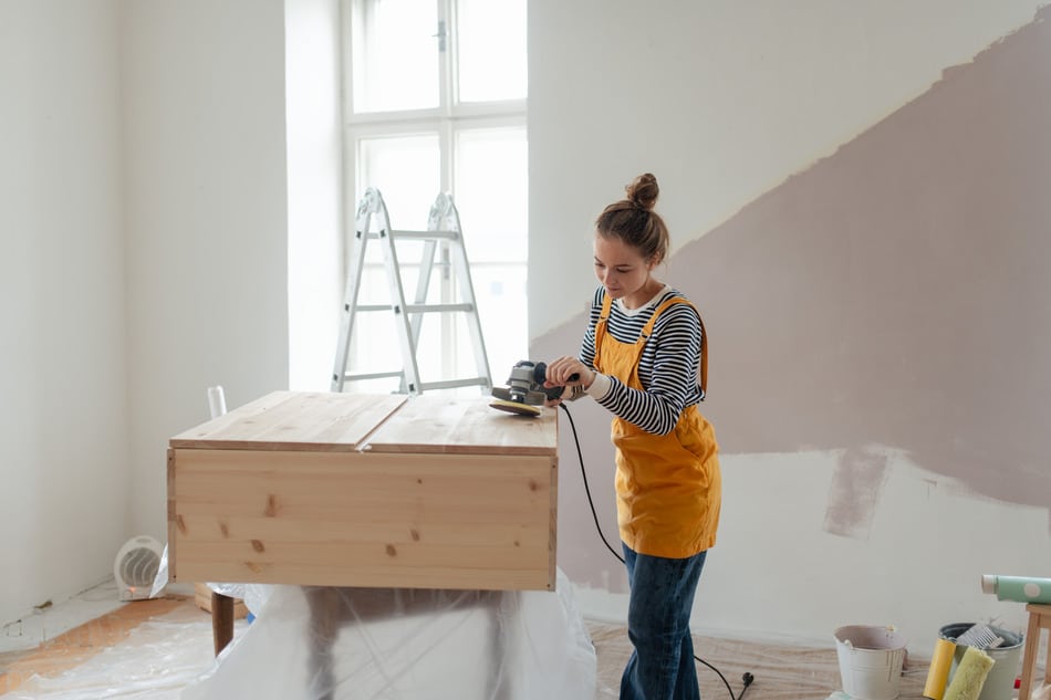 Woman doing some diy cabinet refacing her own for her kitchen.