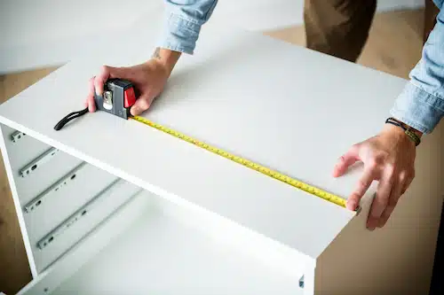cabinet reface expert measuring a cabinet for repair