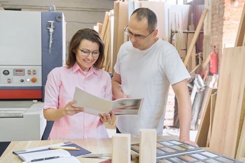 couple shopping for materials for diy cabinet refacing