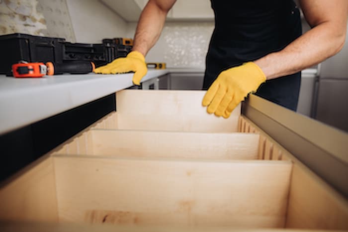 wood refacing expert installing dividers on cabinet to prevent damages