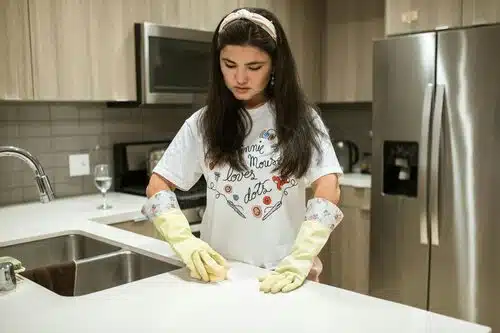 Woman Cleaning a Kitchen Counter