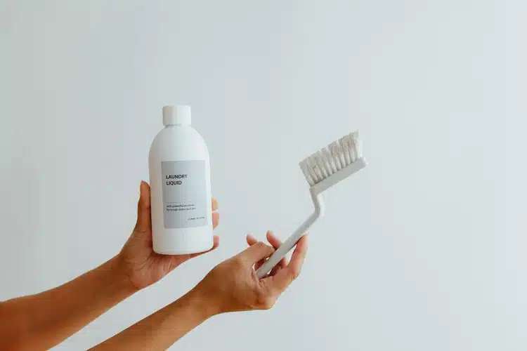 Hands Holding Cleaning Product and Brush